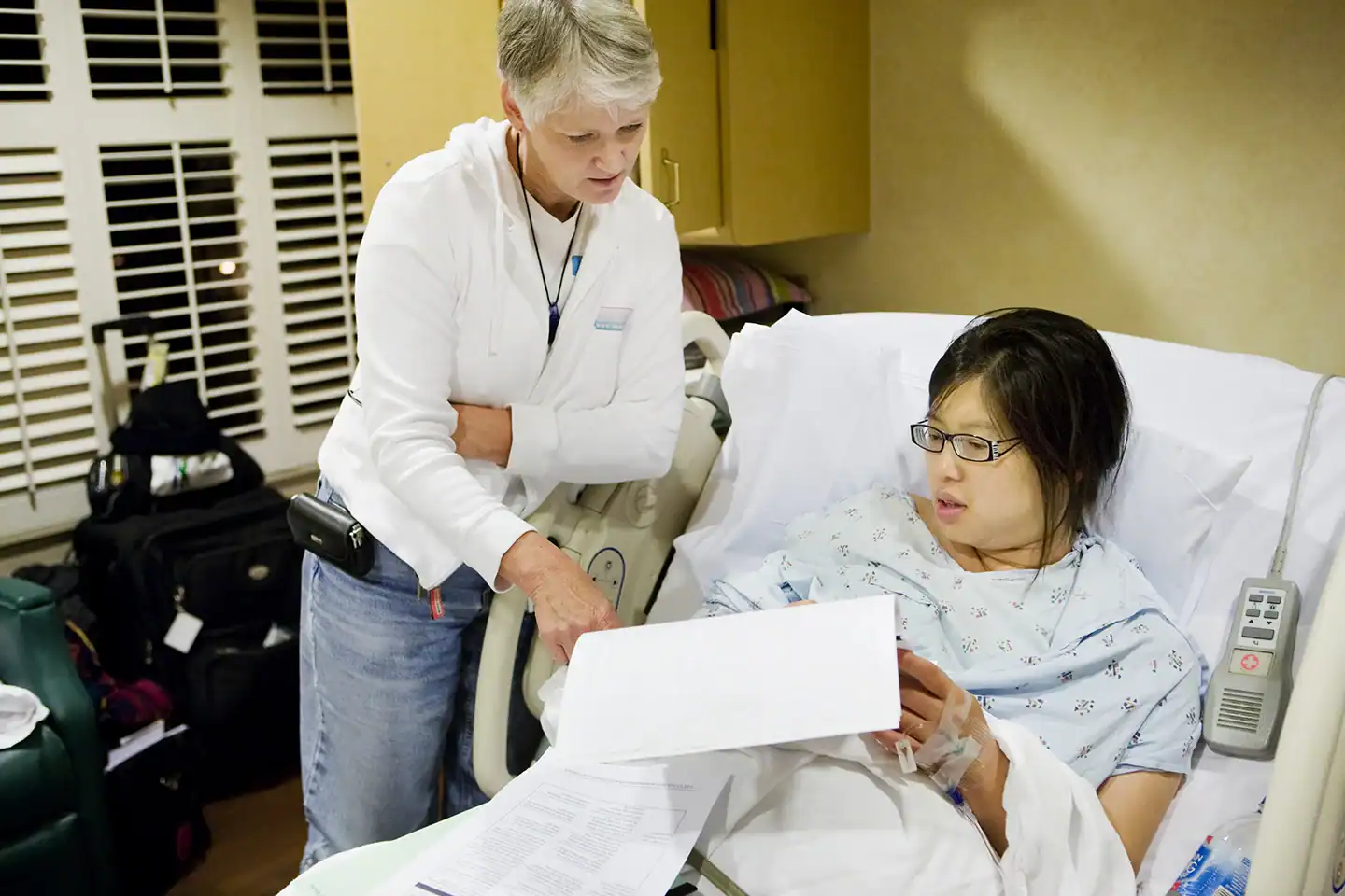 Doula helping her client understand hospital paperwork.