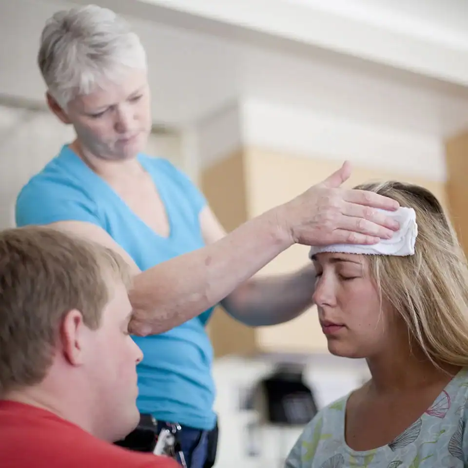 Birth doula providing comfort and support to a woman in labor.