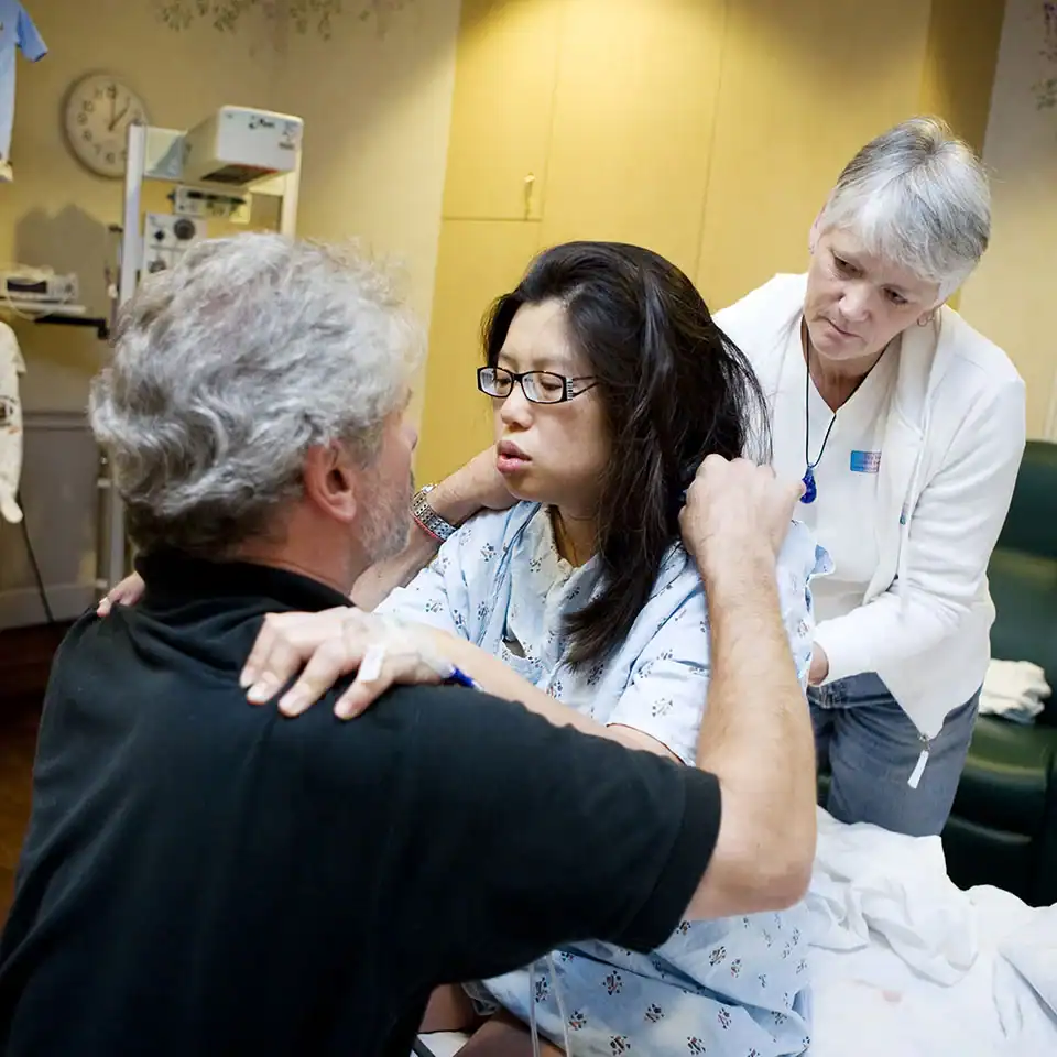 Birth doula providing emotional and physical support to a woman in labor.