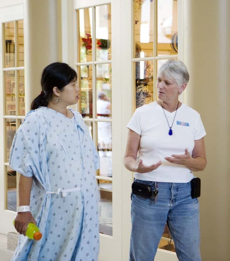 Walking through the hospital lobby in early labor. Doula explaining the next steps of labor.
