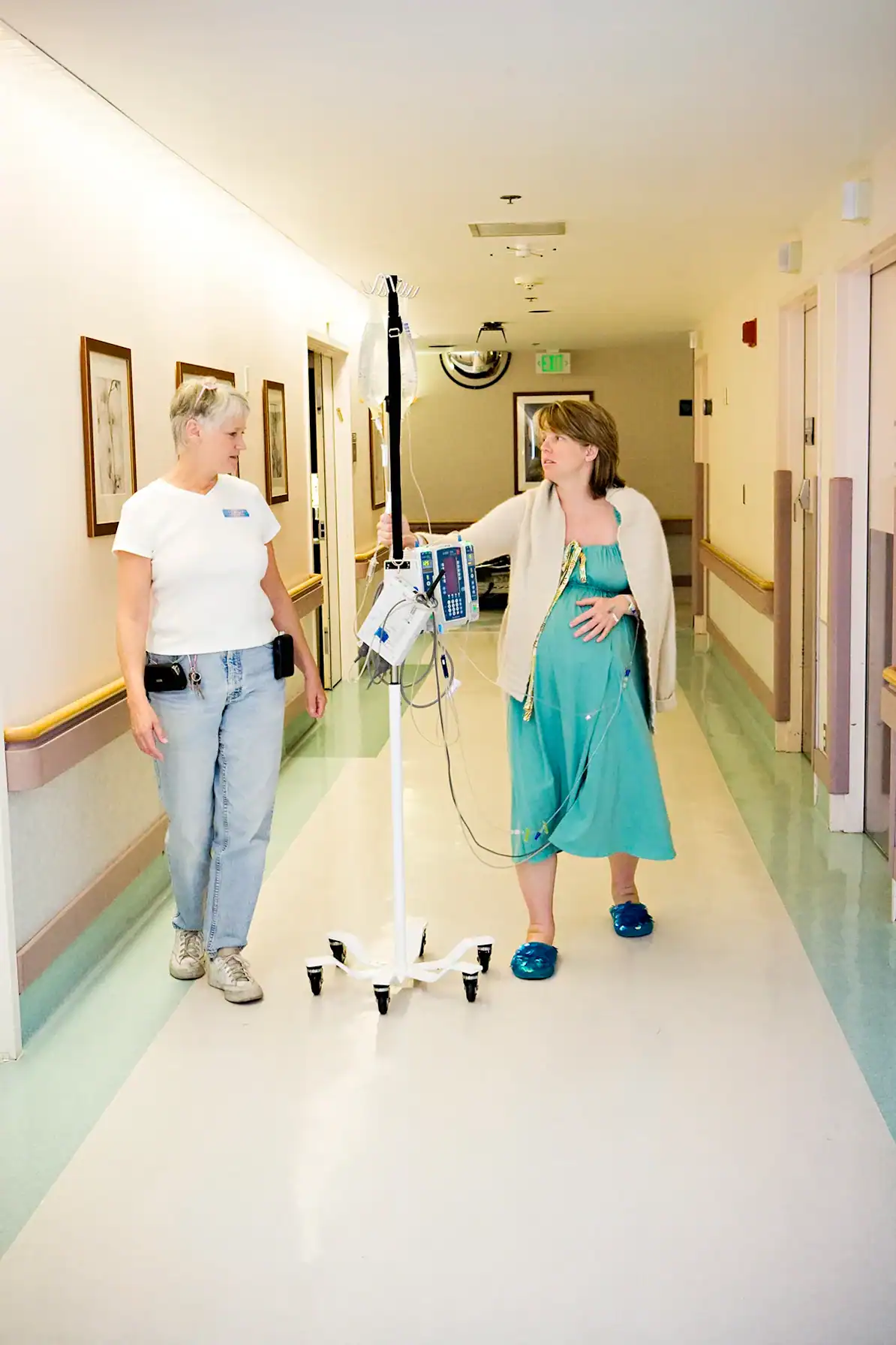 Doula providing emotional and physical support to a woman during her hospital stay.
